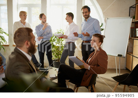 Group of young people, businessmen at business meeting at office space. Scientific conference event, training, brainstorm. 95594905