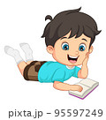 Cute little boy laying and reading a book 95597249