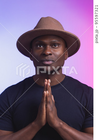 Praying african american man hoping for better. Asking God for good luck success forgiveness. Power of religion belief worship. Holding hands in prayer 95597321