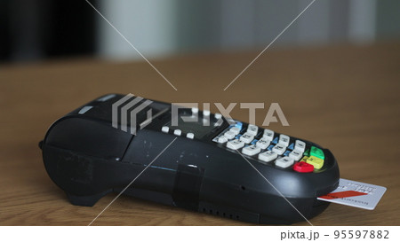 Credit card machine for money transaction. Man hand with credit card swipe through pos terminal and enter pin code. Banking services of electronic money. Financial success and safety. Credit card machine for money transaction. Man hand with credit card swipe through pos terminal and enter pin code. Banking services of electronic money. Financial success and safety. 95597882