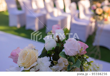 White chairs with pink bows for wedding exit registration. 95598256