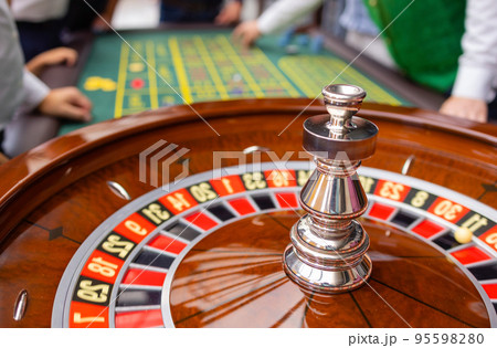 A close up of a blackjack dealer's hands in a casino, very shallow depth of field. 95598280