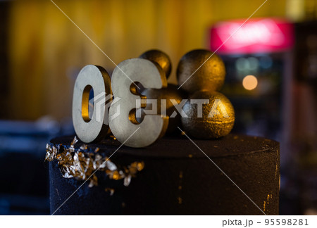 Birthday cake number 30 stars sky and moon concept, blue candle is fire by lighter. Copyspace on right side of screen. Close-up view. 95598281