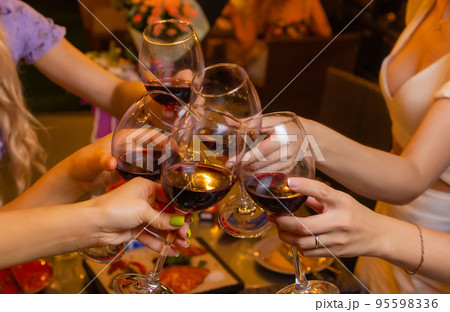Clinking glasses with alcohol and toasting, party. 95598336