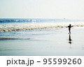 Young boy dancing on the beach 95599260