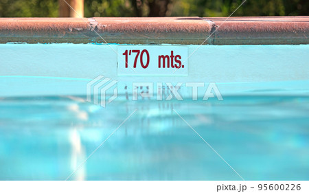 Pool depth sign at the edge of the swimming pool Pool depth sign at the edge of the swimming pool 95600226