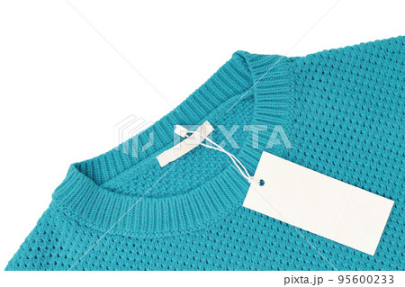White blank rectangular clothing tag on turquoise knitted sweater isolated on white background White blank rectangular clothing tag on turquoise knitted sweater isolated on white background 95600233