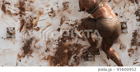 Woman competing in a mud run race Woman competing in a mud run race 95600952
