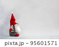 Christmas gnome in red hat side view holiday card on light winter background 95601571