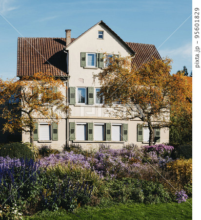 House with nice garden in fall. Flowers in the City Park of Bietigheim-Bissingen, Baden-Wuerttemberg, Germany, Europe. Autumn Park and house, nobody, bush and grenery House with nice garden in fall. Flowers in the City Park of Bietigheim-Bissingen, Baden-Wuerttemberg, Germany, Europe. Autumn Park and house, nobody, bush and grenery 95601829