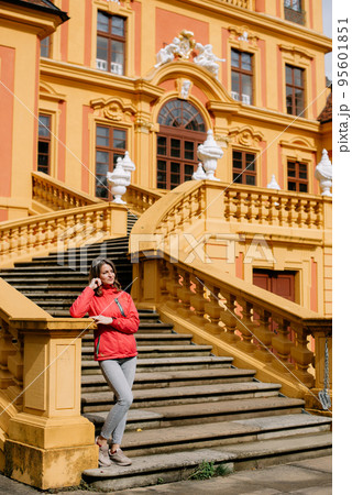 Beautiful Girl Posing Near Favorite Palace At Ludwigsburg, Germany. Favorite Castle Is The Oldest German Porcelain Castle Near The Village Of Forch Near Rastatt. Schloss Favorite, Baden-Wuerttemberg. 95601851