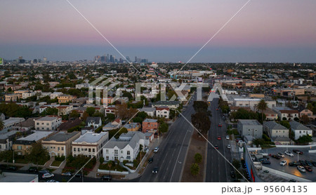 Los Angeles hot sunset view with palm tree and downtown in background. California, USA theme - background. Art photography Los Angeles hot sunset view with palm tree and downtown in background. California, USA theme - background. Art photography 95604135