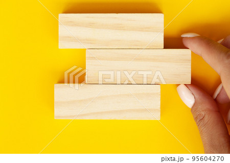 Woman hand stacked wooden blocks with space for text 95604270