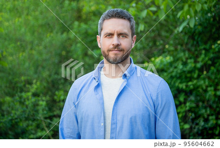 Portrait of handsome professional man in blue shirt natural background Portrait of handsome professional man in blue shirt natural background 95604662