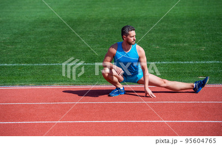 mature man stretching his legs before a stadium workout, stretch 95604765