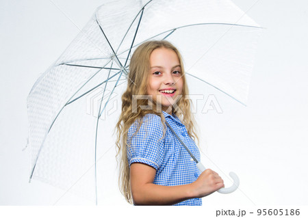 Small girl with umbrella in rainy weather. Happy childhood. School time. Autumn fashion. Child Feeling protected at this autumn. Happy little girl with umbrella. I love autumn. Beauty in autumn style 95605186