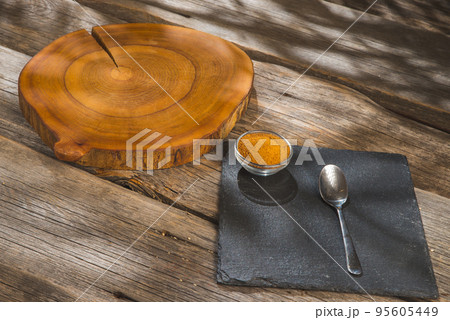 Bowl and scoop of brown sugar with coconut on wooden background Bowl and scoop of brown sugar with coconut on wooden background 95605449