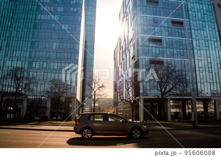 Sun goes through city skyscraper public transport scene in Gdansk. Oliva business district Transport city traffic. Trams buses cars City Traffic Jam 95606008