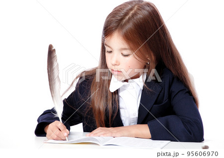 Happy and cute teen school girl writes in a book or notebook Happy and cute teen school girl writes in a book or notebook 95606970