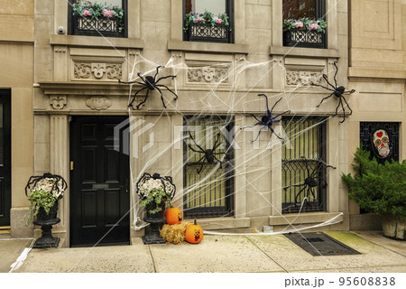 Front of apartment building decorated with spider web for Halloween holiday in Manhattan New York Front of apartment building decorated with spider web for Halloween holiday in Manhattan New York 95608838