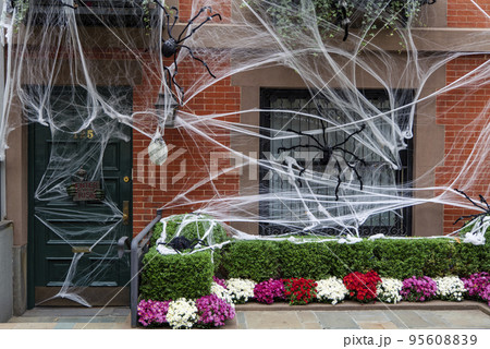 Front of apartment building decorated with spider web for Halloween holiday in Manhattan New York 95608839