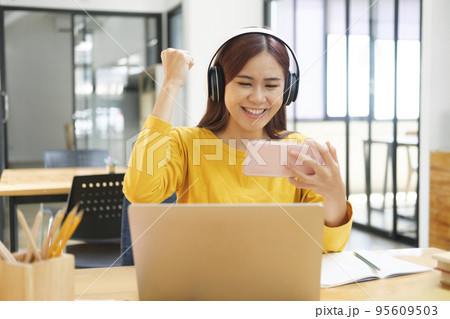 Young woman happy with her online study. 95609503