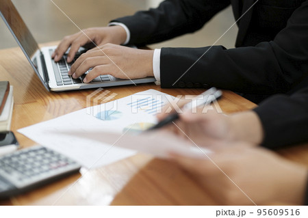 Businessmen working, discussing, analyzing using laptop and graphs. Businessmen working, discussing, analyzing using laptop and graphs. 95609516