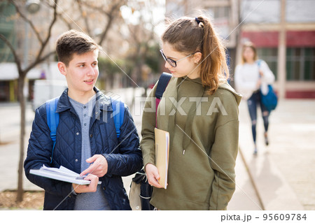 Girl and guy are discussing student issues on street Girl and guy are discussing student issues on street 95609784