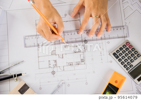 Architect drawing with ruler on house plan blueprint paper for repair tools on table 95614079