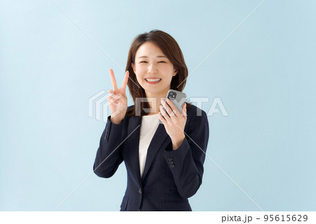 スマホを持つ女性 青背景 スマホを持つ女性 青背景 95615629