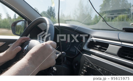 Izhevsk, Russia, August 16, 2022. Person steering wheel with one hand close up. 95615975