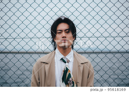 フェンスの前に立つ男性 95618169