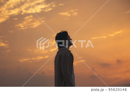 夕方に海辺でスマホを見る男性 夕方に海辺でスマホを見る男性 95620148