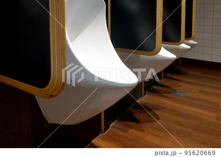 New and modern urinals in the men's toilet. New and modern urinals in the men's toilet. 95620669