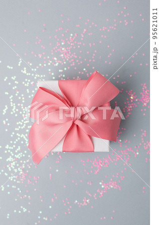 Gift or present box and stars confetti on gray table top view. Flat lay composition for birthday, mother day, christmas, new year, valentine or wedding. Stylish luxury monochrome concept, sale Gift or present box and stars confetti on gray table top view. Flat lay composition for birthday, mother day, christmas, new year, valentine or wedding. Stylish luxury monochrome concept, sale 95621011