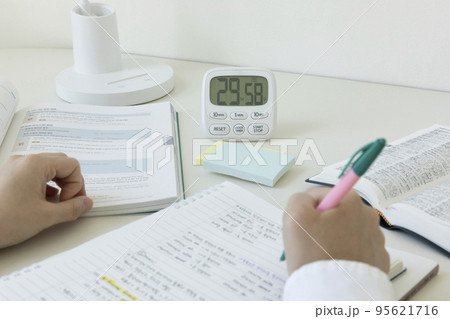 studying at home, study desk setup_studying while checking the time 95621716