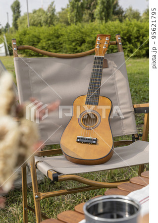 camping mood aesthetics_camping gear and ukulele 95621795