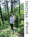 korean young woman hiking and plogging__picking up litter, garbage 95622492