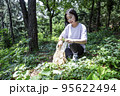 korean young woman hiking and plogging__picking up litter, garbage 95622494