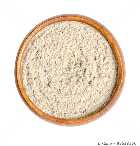 Bentonite, dry powder of montmorillonite in a wooden bowl. Used in folk medicine as medicinal clay, for internal and external use, it is an absorbent swelling clay, formed from weathered volcanic ash. Bentonite, dry powder of montmorillonite in a wooden bowl. Used in folk medicine as medicinal clay, for internal and external use, it is an absorbent swelling clay, formed from weathered volcanic ash. 95623556
