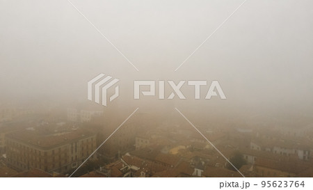 foggy cityscape aerial drone view of town center Cremona, Lombardy, Italy 95623764