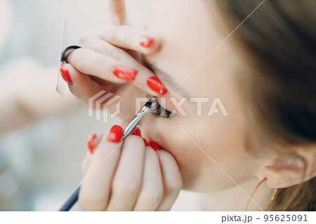 Beautiful young woman applying makeup beauty visage brush. Beautiful young woman applying makeup beauty visage brush. 95625091