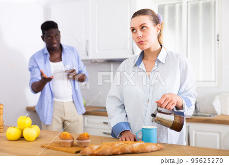 Domestic quarrel of husband and wife in kitchen during breakfast Domestic quarrel of husband and wife in kitchen during breakfast 95625270