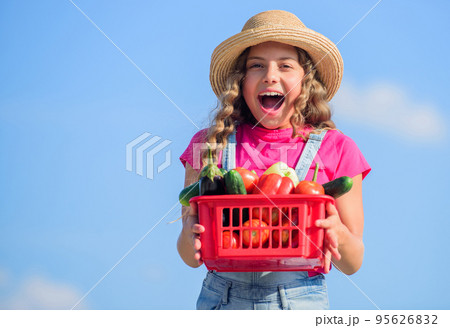 Selling homegrown food concept. Natural vitamin nutrition. Vegetables market. Organic vegetables. Girl cute child farming. Gathering vegetables in basket. Village rustic style. Sunny day at farm 95626832