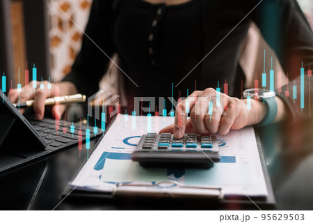 Business and financial concepts about office work. Analysts discuss business with a calculator as a tool. 95629503