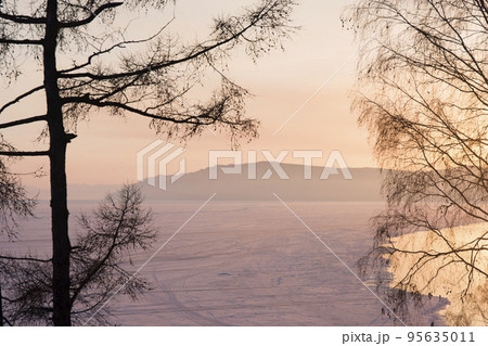 Beautiful sunset on frozen lake Baikal. Winter landscape. Beautiful sunset on frozen lake Baikal. Winter landscape. 95635011
