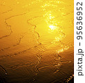 Wave on the beach at sunset 95636952