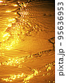 Wave on the beach at sunset 95636953