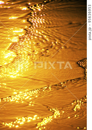 Wave on the beach at sunset 95636953