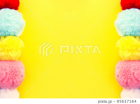 Colorful fluffy pompons on bright background. Fashion decoration festive template. 95637164